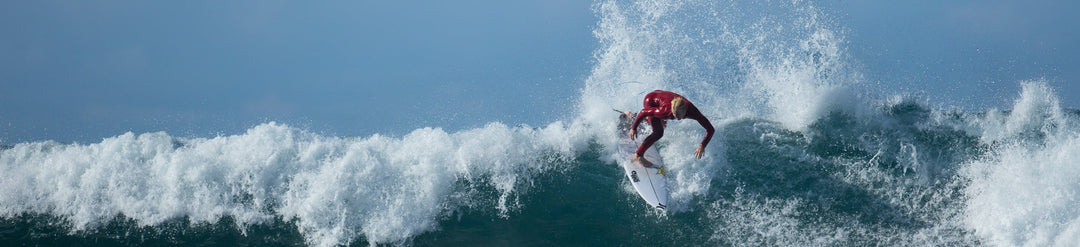 Man surfing into wave just as it is breaking